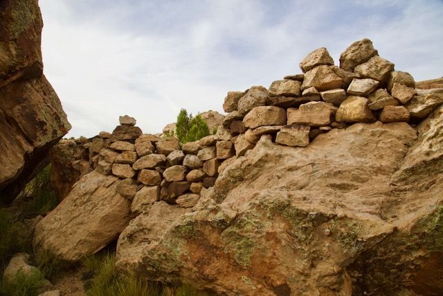 Stacked stone wall among sandstone rocks and grass, Canyon of the Ancients Ranch, Montezuma County, Colorado