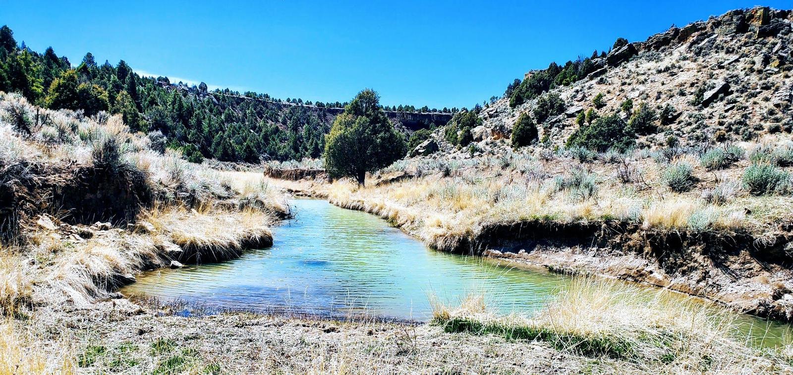 River bend and a rocky slope at Chama River Canyon Ranch, Rio Arriba County, New Mexico