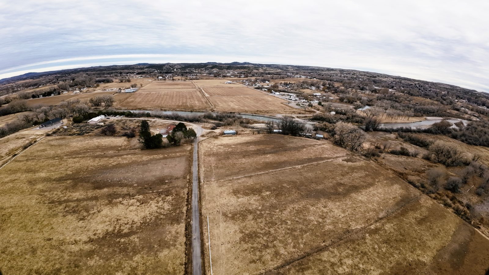 Drone aerial of irrigated fields and a farm lane at Gomez Farm, San Juan County, New Mexico
