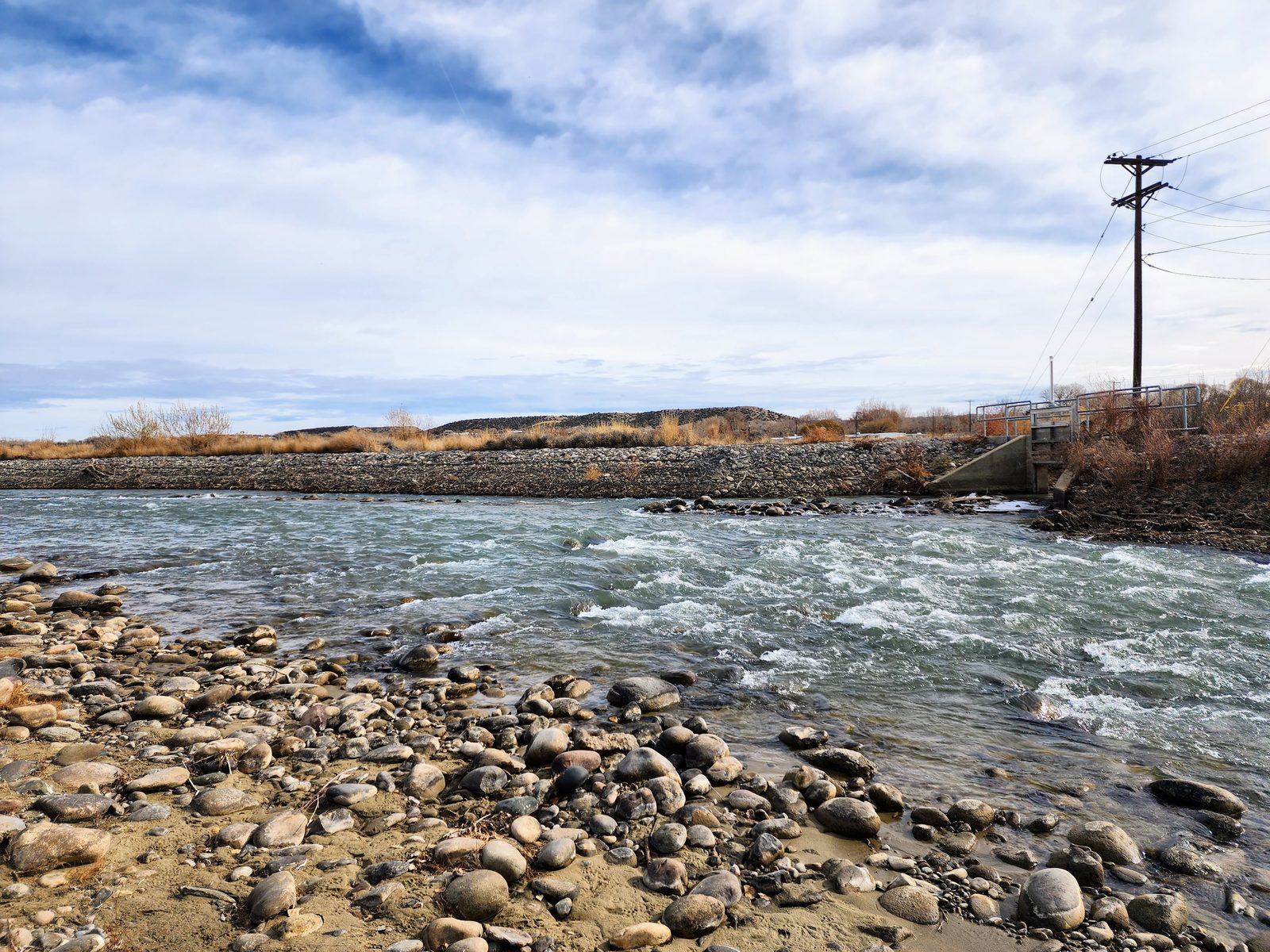 River running past a rocky gravel bank at Gomez Farm, San Juan County, New Mexico