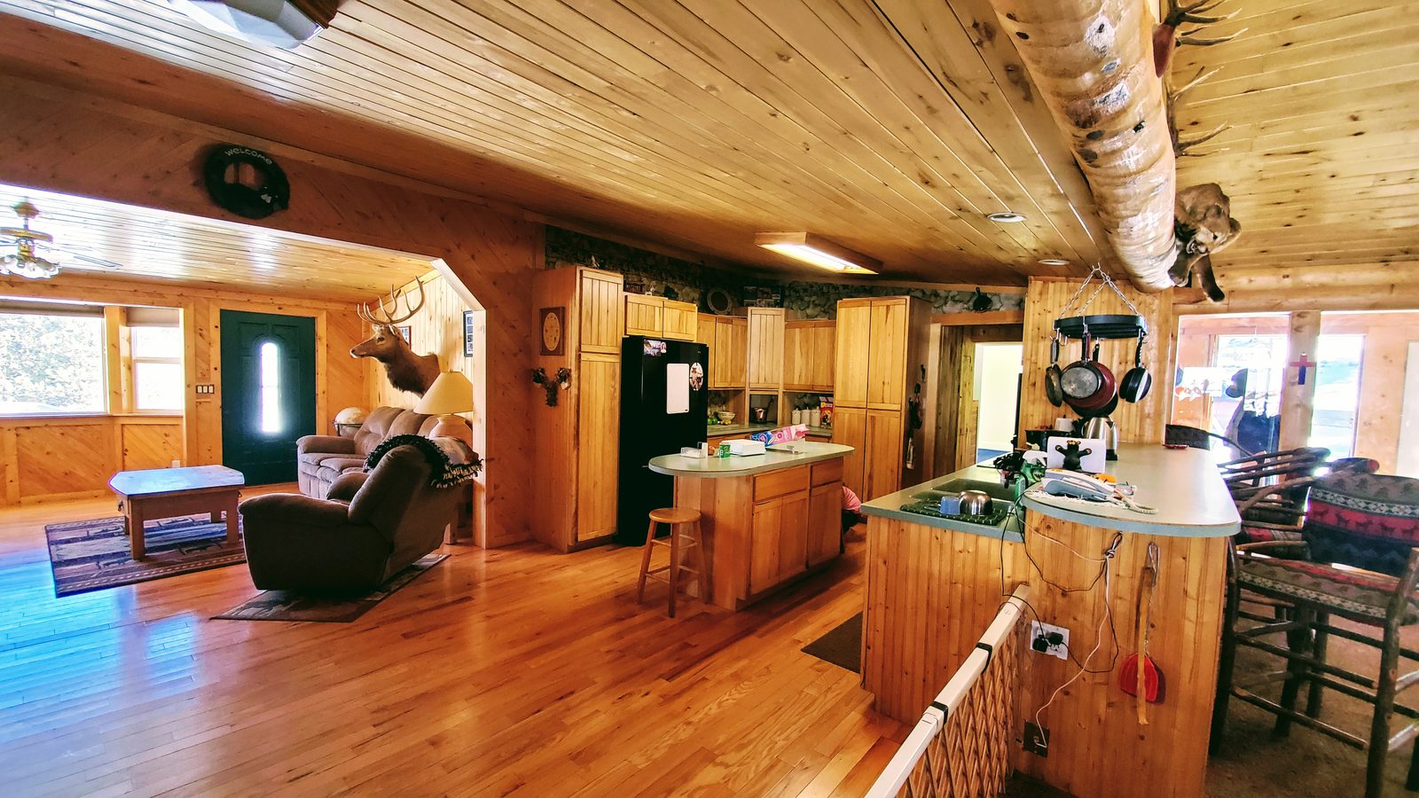 Open kitchen and great room with wood ceilings and hardwood floors at Horse Creek Ranch, Lake George, Teller County, Colorado