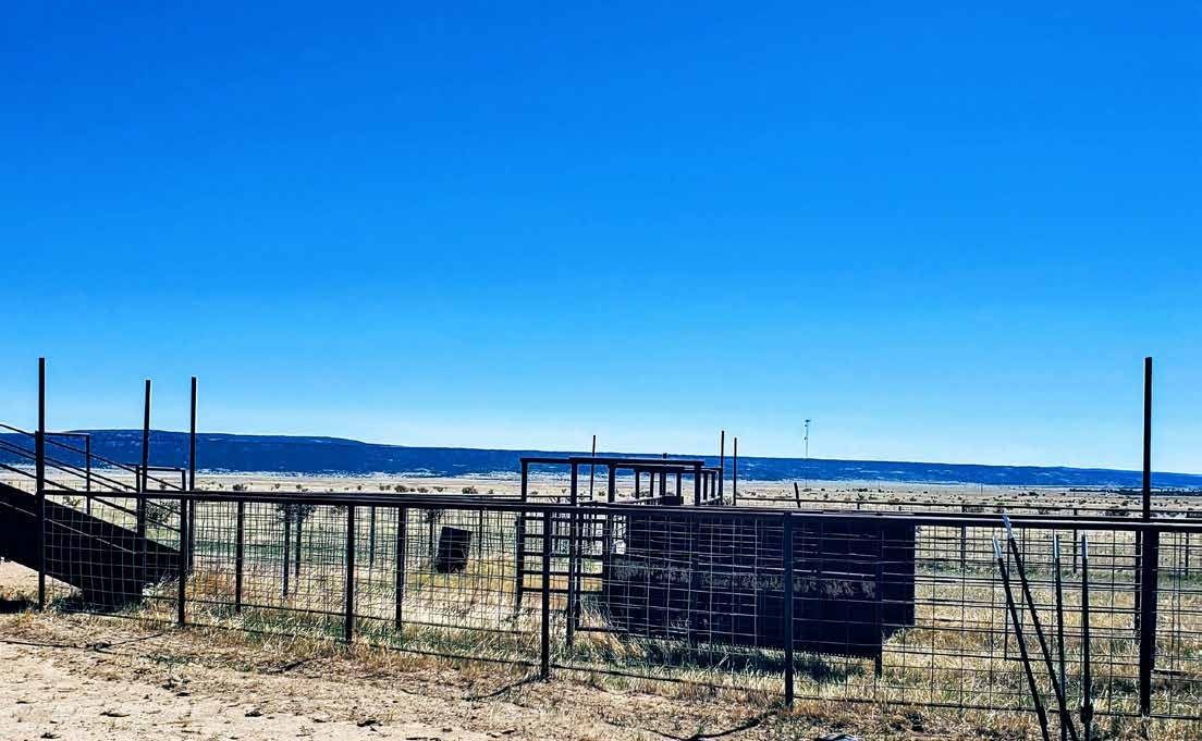 Metal livestock pens on open grassland with a distant mesa at Long Canyon Ranch, Las Animas County, Colorado