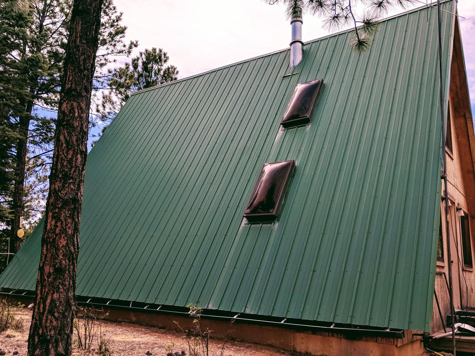 Green metal roof among pines at Wilderness Ridge, Las Animas County, Colorado